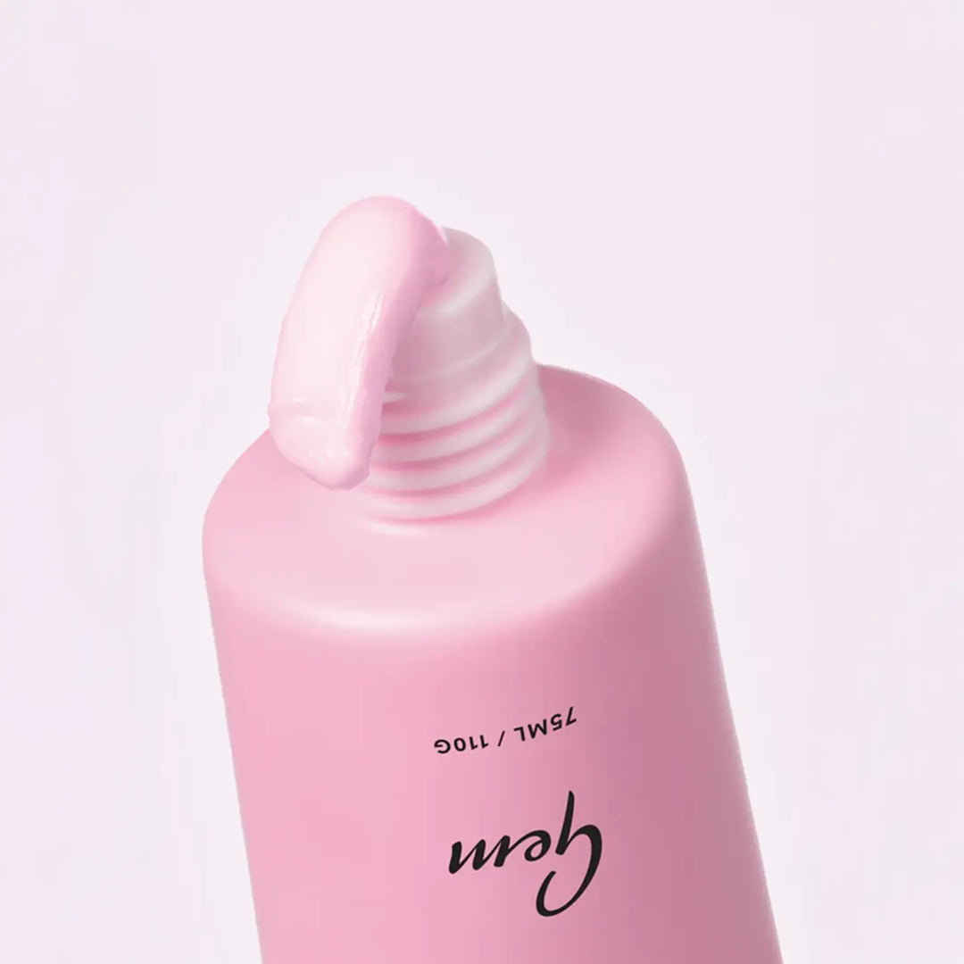 Pink bottle with pump dispenser on a light pink background