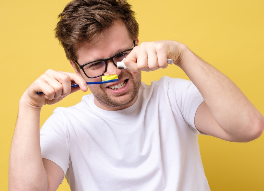 Blog Man looking confused adding toothpaste to toothbrush