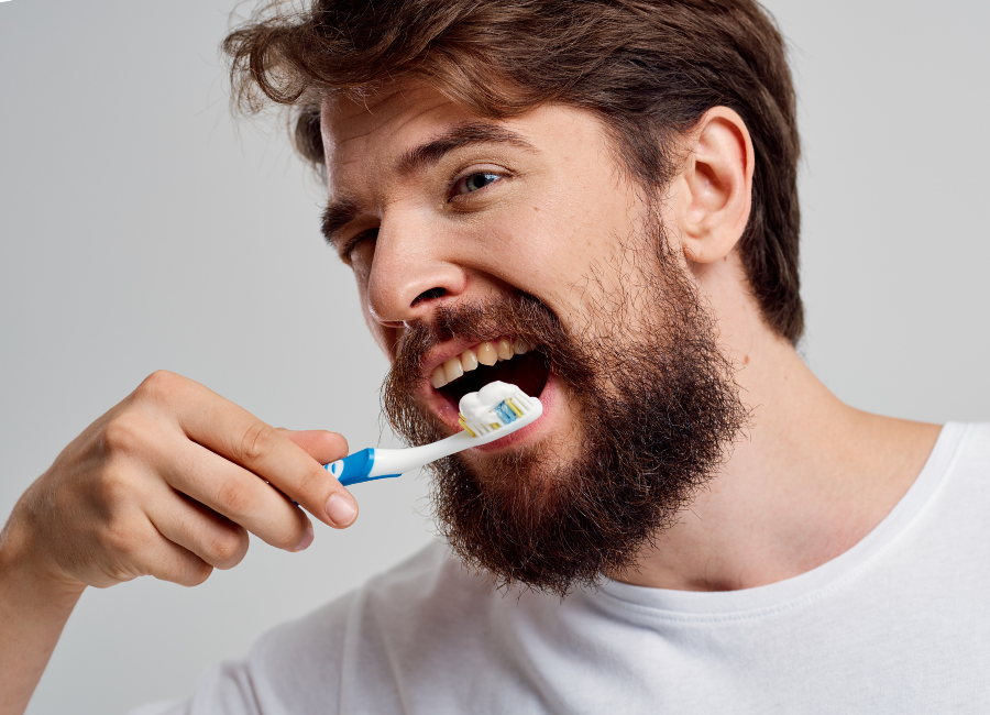 Man with beard brushing teeth