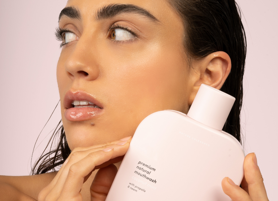 Woman holding Gem Premium Natural Mouthwash