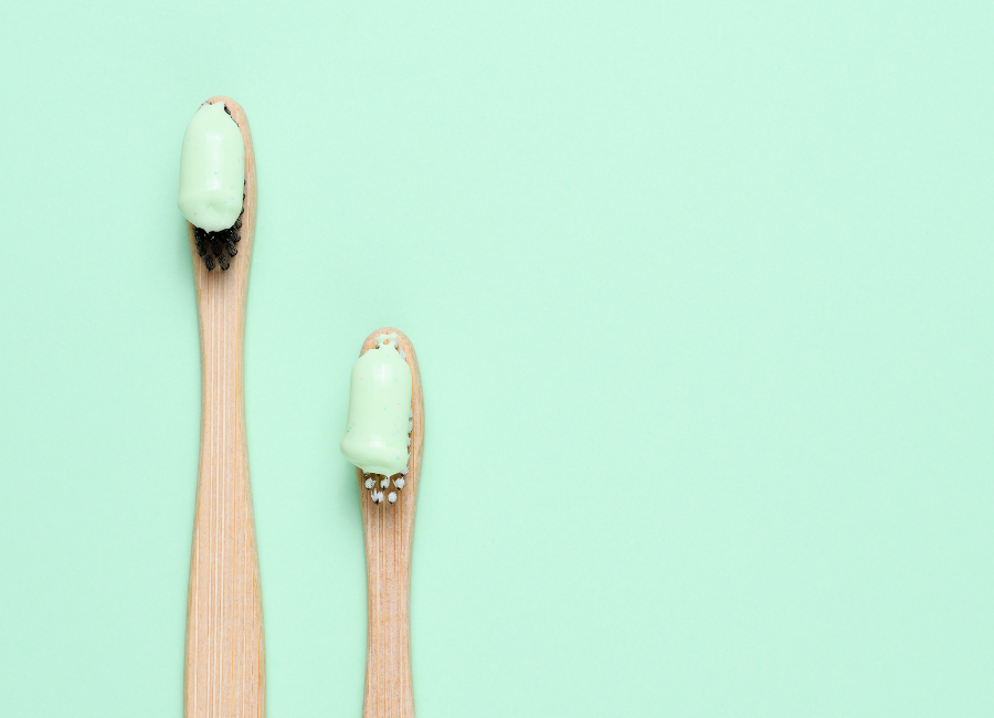 Two toothbrush with pastel green toothpaste