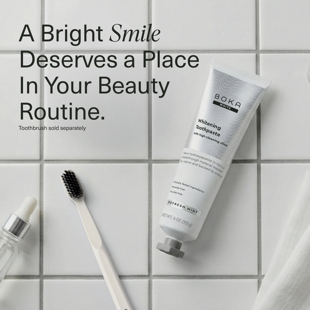 Boka Refresh Mint whitening toothpaste tube on white tiles beside a toothbrush