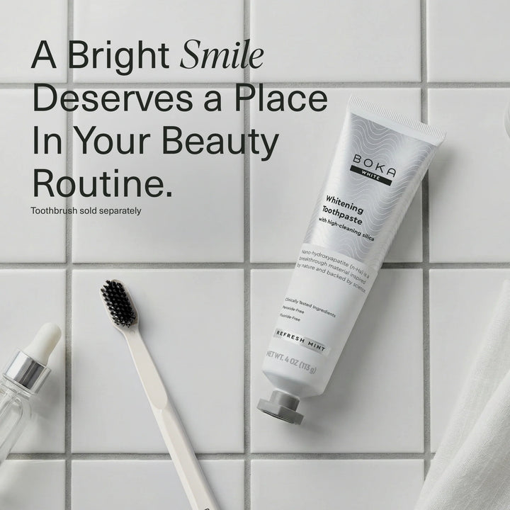 Boka Refresh Mint whitening toothpaste tube on white tiles beside a toothbrush