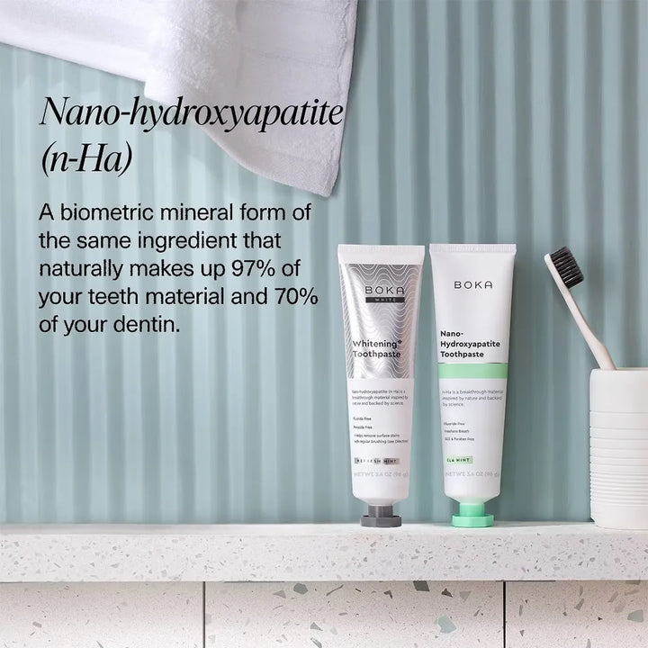 Boka Whitening and Ela Mint toothpaste tubes on a bathroom shelf with nano-hydroxyapatite (n-Ha) explainer