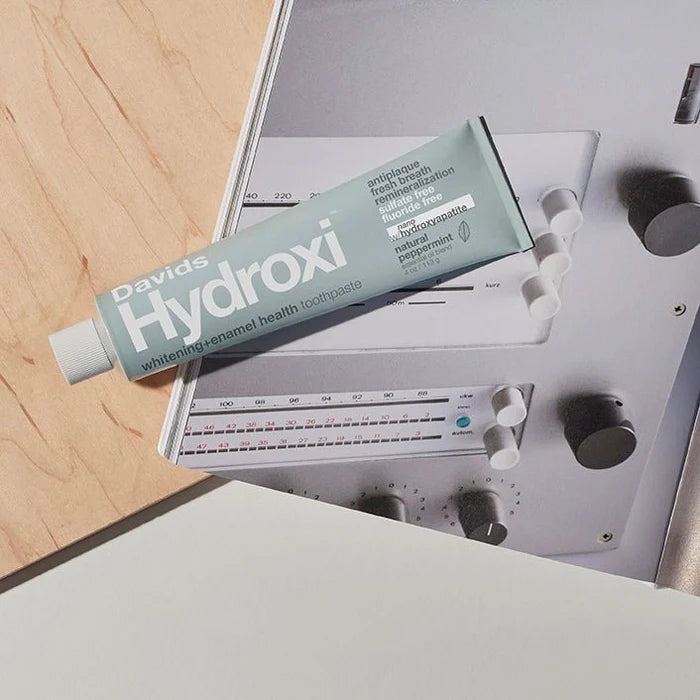 Tube of David's Hydroxi toothpaste on a metallic surface