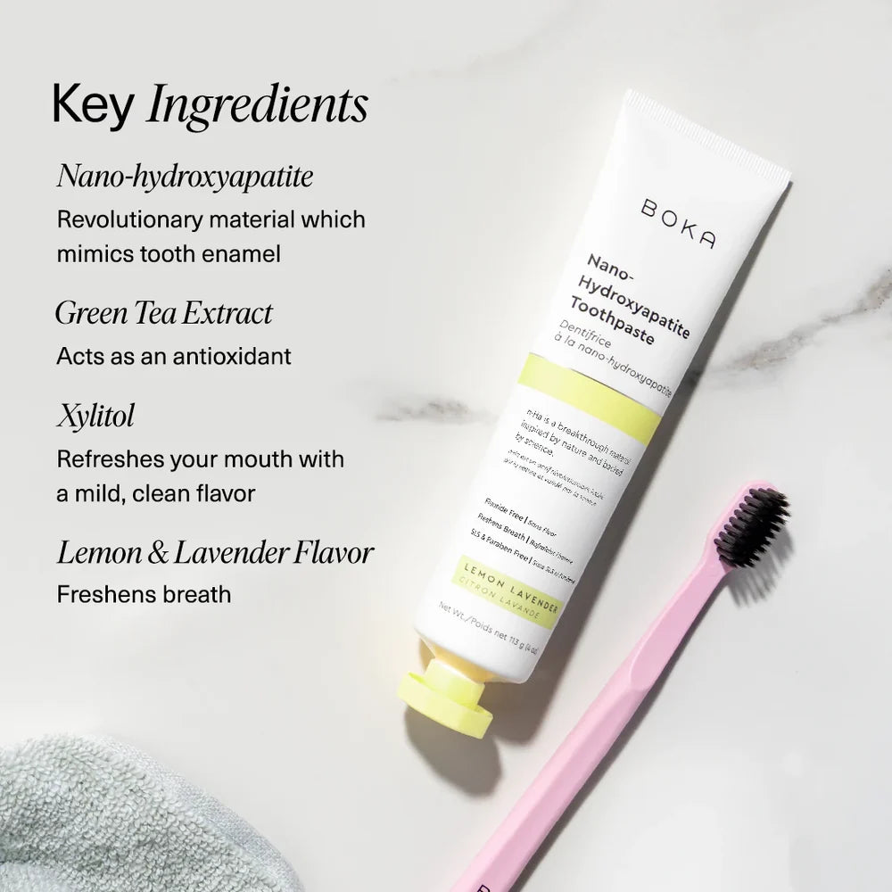 Boka Lemon Lavender toothpaste on marble with a pink toothbrush beside nano-hydroxyapatite, green tea and xylitol callouts