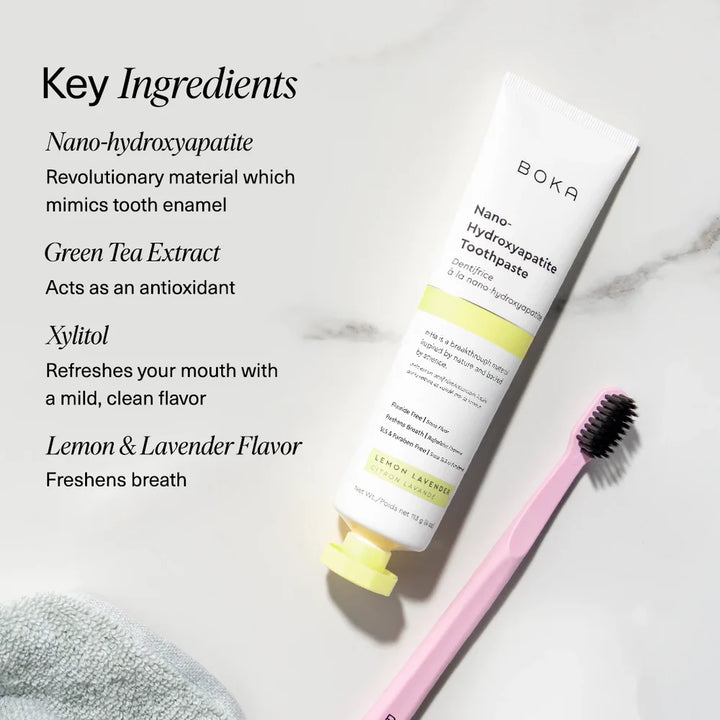 Boka Lemon Lavender toothpaste on marble with a pink toothbrush beside nano-hydroxyapatite, green tea and xylitol callouts