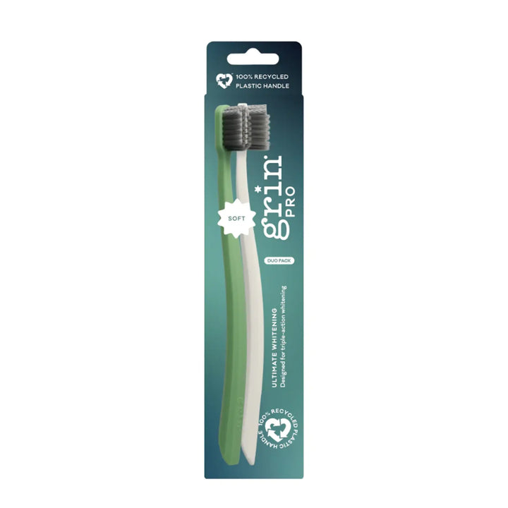 Green toothbrush with packaging on a white background