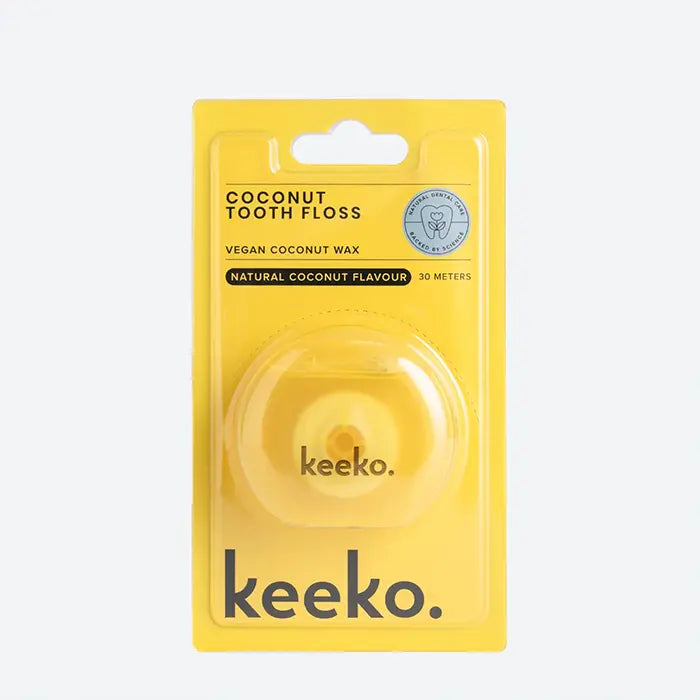 Yellow package of kecko coconut tooth floss on a white background