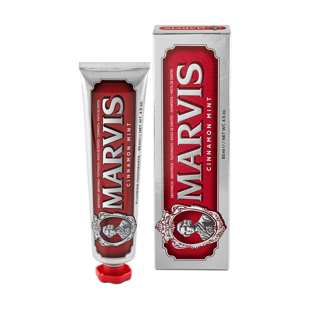 Marvis Cinnamon Mint toothpaste, 85ml, shown as a silver tube with a crimson label and red cap next to the red and silver carton