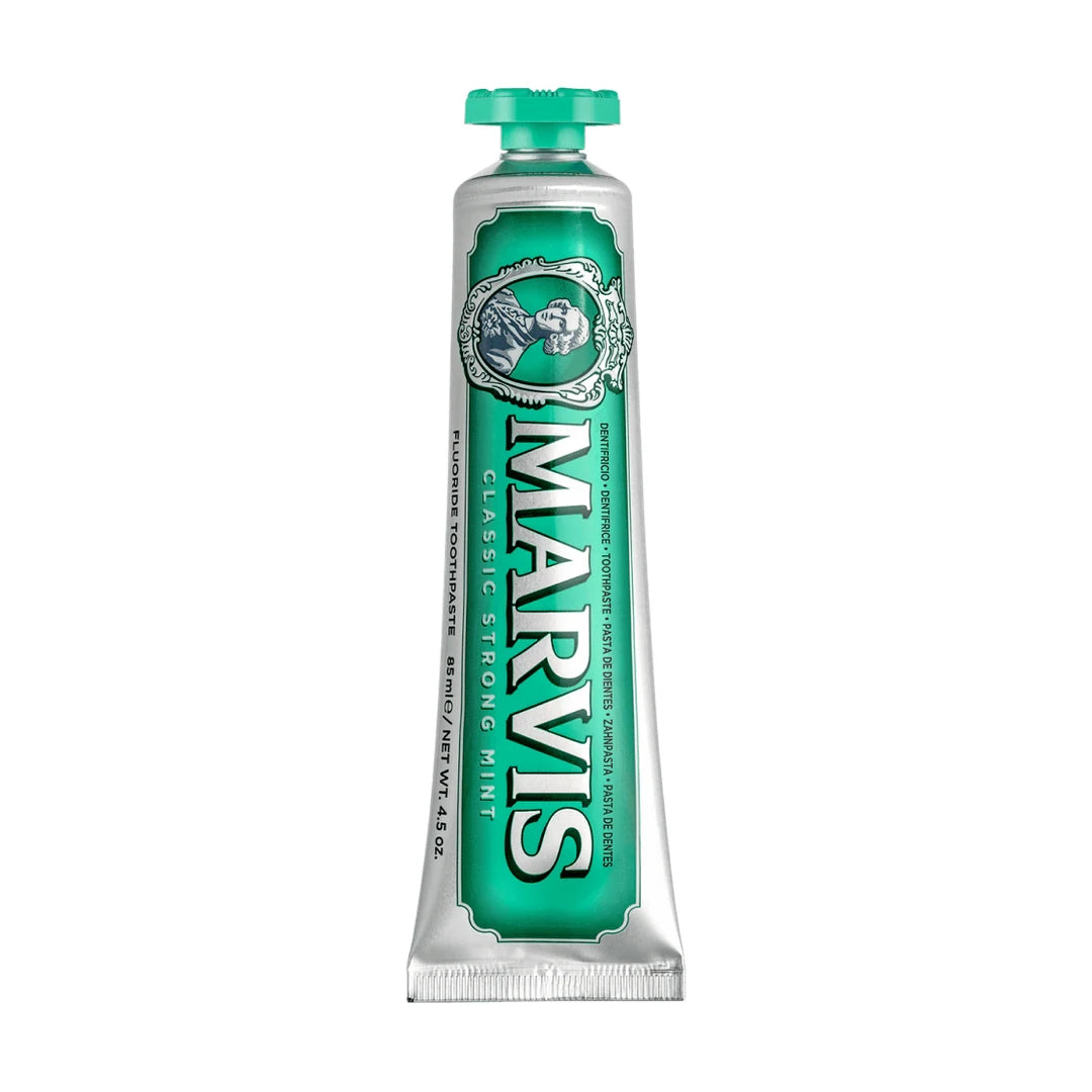 Marvis Classic Strong Mint 85ml toothpaste tube shown cap up, silver with a green label, white MARVIS lettering and an oval portrait