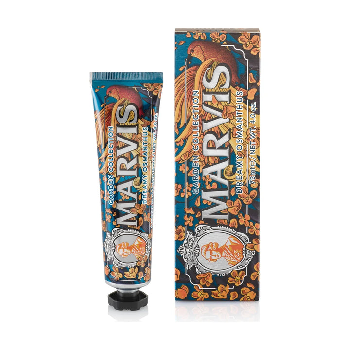 Marvis Dreamy Osmanthus toothpaste 75ml tube in deep teal with orange blossoms and a russet bird, standing beside its matching carton