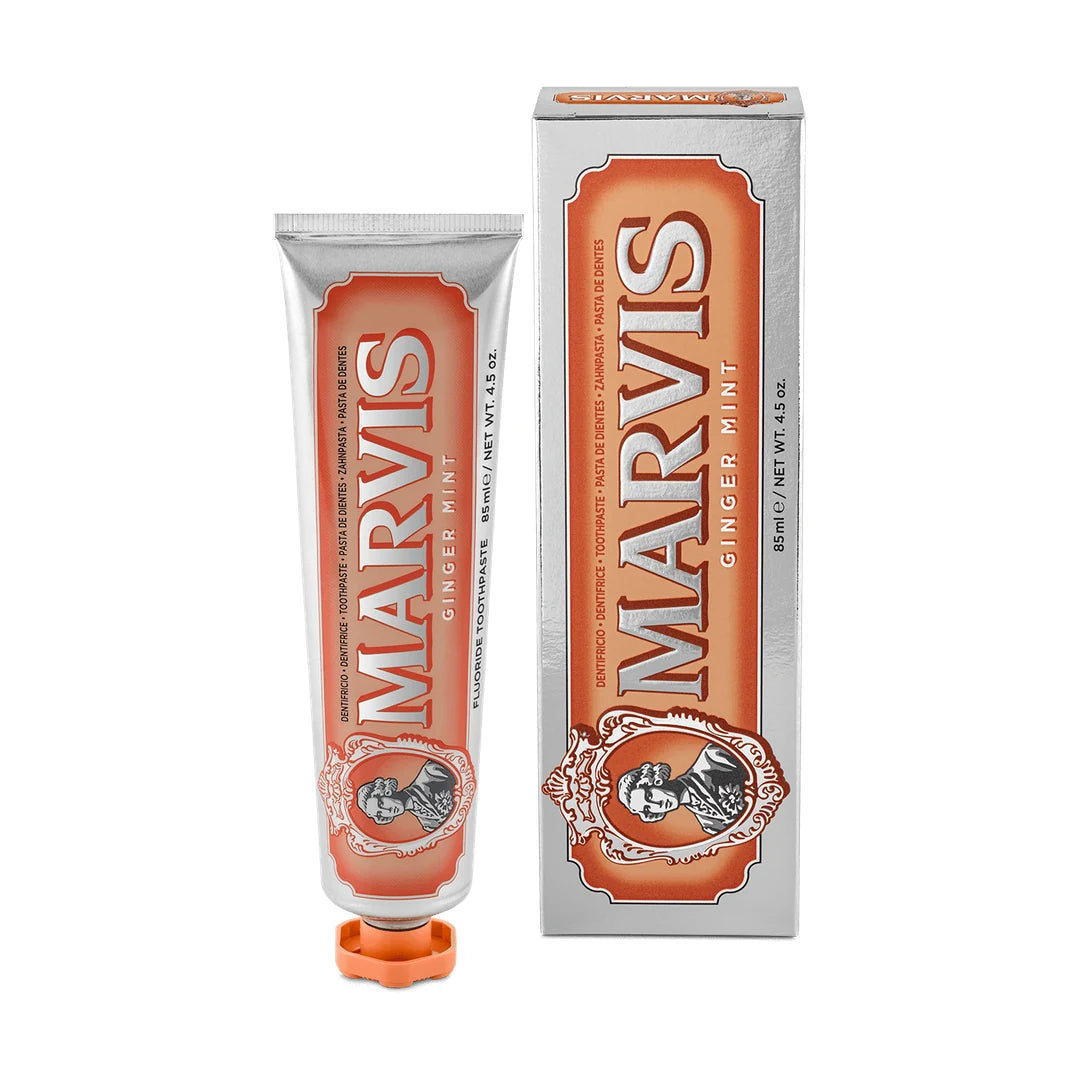 Marvis Ginger Mint 85ml toothpaste tube, orange label on silver with an orange cap, upright beside its matching carton on white