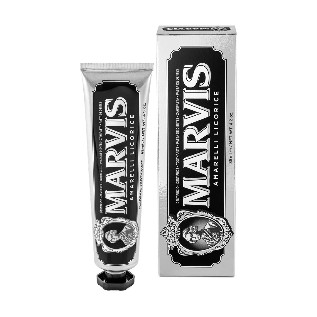 Marvis Amarelli Licorice Mint toothpaste tube, 85ml, black label and faceted black cap, beside a silver carton with a black panel