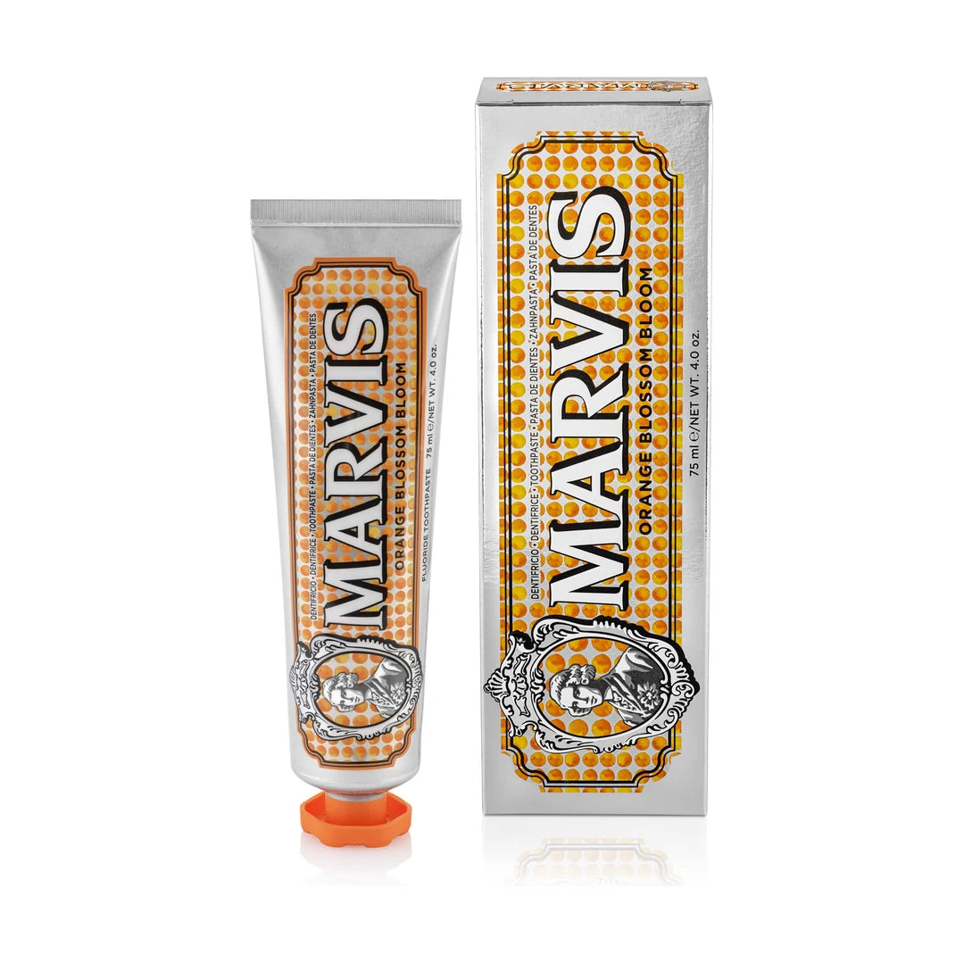 Marvis Orange Blossom Bloom toothpaste 75ml, silver tube with orange cap and orange dotted label beside its silver carton on white