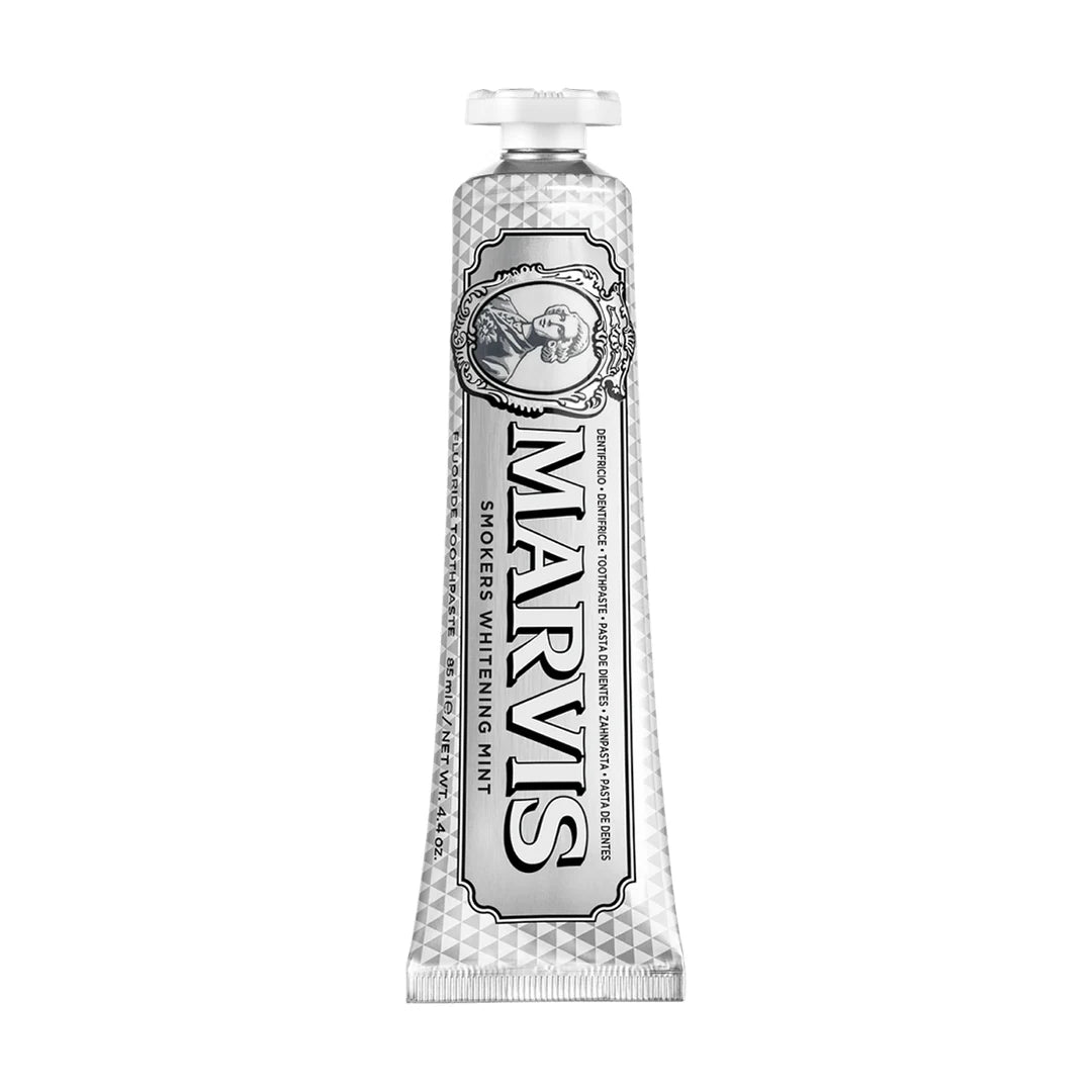 Marvis Smokers Whitening Mint 85ml tube standing upright, faceted silver finish with black lettering, an oval cameo and a white cap