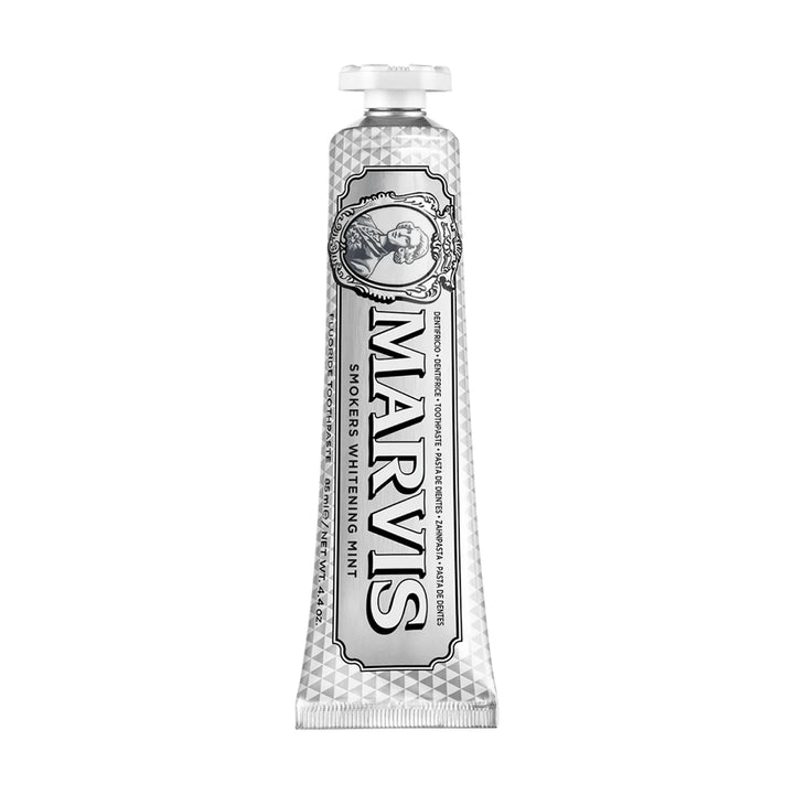 Marvis Smokers Whitening Mint 85ml tube standing upright, faceted silver finish with black lettering, an oval cameo and a white cap