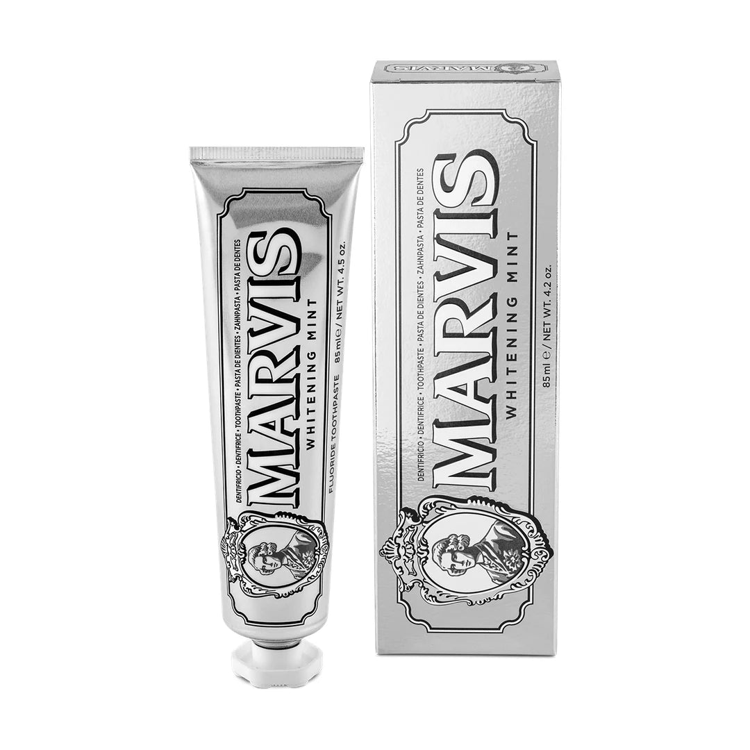 Marvis Whitening Mint toothpaste 85ml in a smooth silver tube with a white cap, next to its silver carton with black lettering
