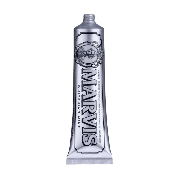 Uncapped silver Marvis Whitening Mint 85ml toothpaste tube showing the oval Marquis portrait and outlined black Marvis lettering