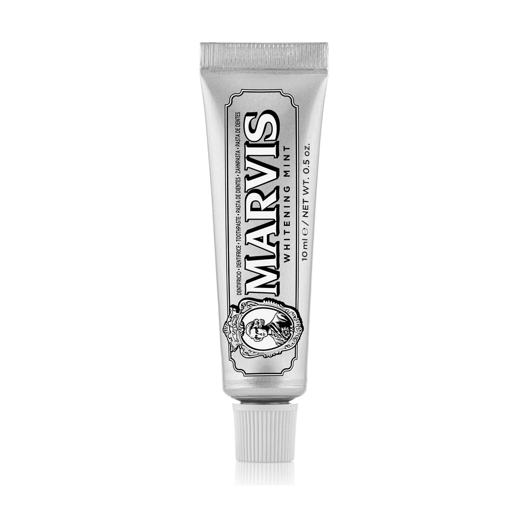 Marvis Whitening Mint 10ml travel toothpaste in a slim silver tube with a white ribbed cap, black lettering and a cameo, on white