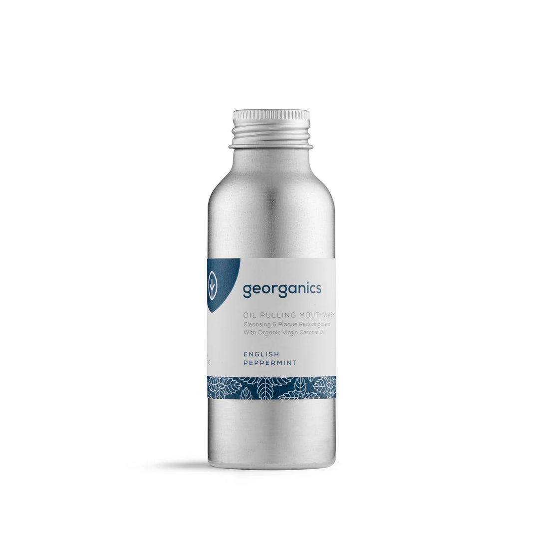 Georganics Oil Pulling Mouthwash in English Peppermint — a brushed aluminium bottle with a navy leaf-patterned label, made with organic virgin coconut oil.
