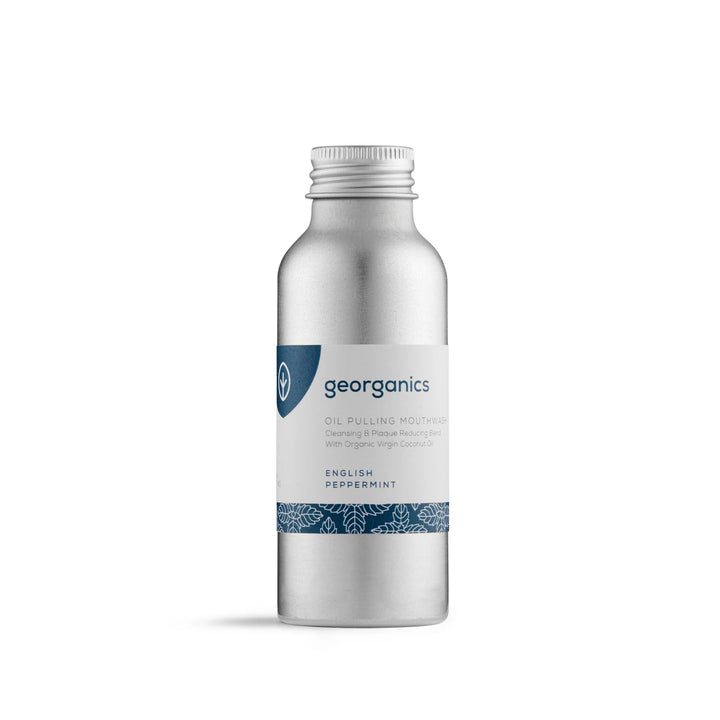 Georganics Oil Pulling Mouthwash in English Peppermint — a brushed aluminium bottle with a navy leaf-patterned label, made with organic virgin coconut oil.