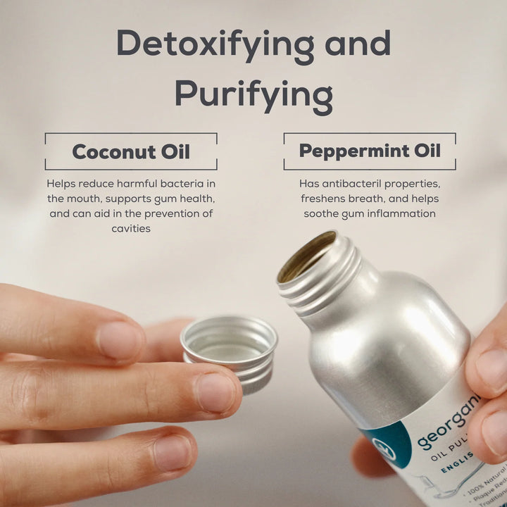 Hands opening a Georganics oil pulling mouthwash bottle, with notes on how coconut oil and peppermint oil detoxify and purify the mouth.