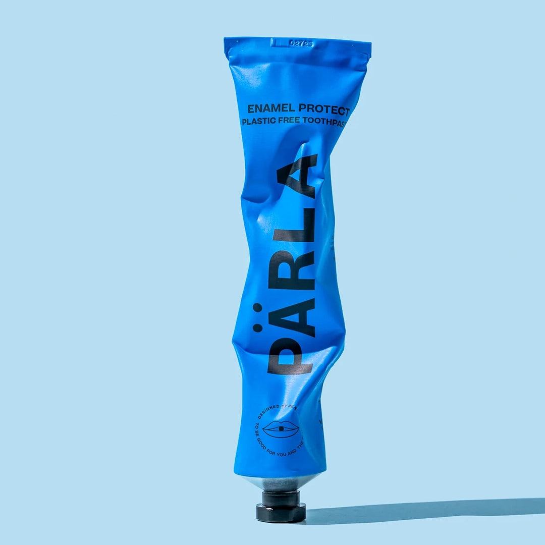 Part used PÄRLA Enamel Protect toothpaste tube, showing the aluminium squeezes flat for recycling