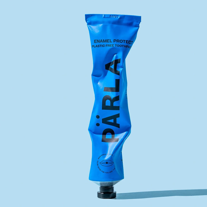 Part used PÄRLA Enamel Protect toothpaste tube, showing the aluminium squeezes flat for recycling