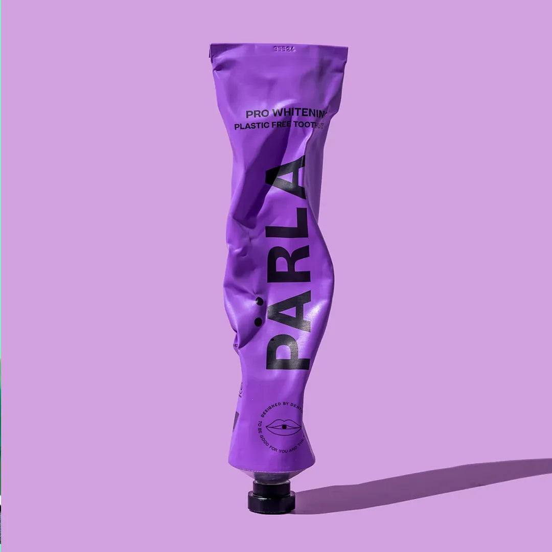 Part used PÄRLA Pro Whitening toothpaste tube, showing the aluminium squeezes flat for recycling