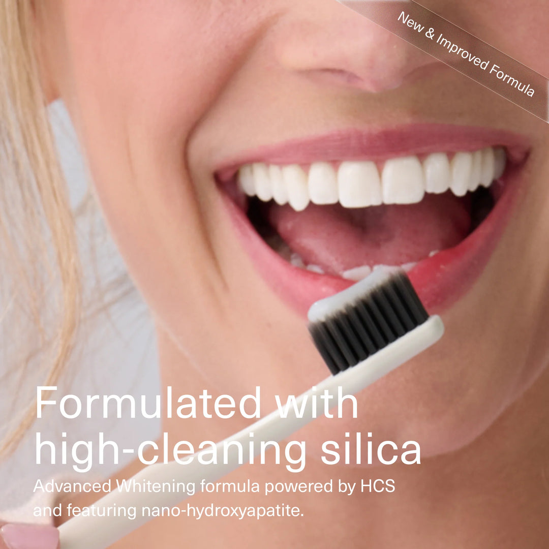 Smiling woman brushing her teeth — Boka whitening formula with high-cleaning silica and nano-hydroxyapatite