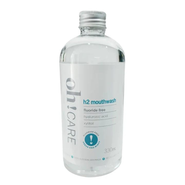 Oh Care h2 mouthwash clear bottle with a silver cap and white label reading fluoride free, hyaluronic acid and xylitol, on a white background